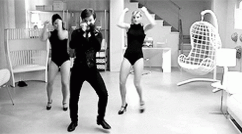 Man and Two Women Dancing in Room