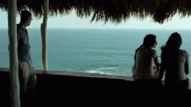 Man and Two Women Looking Over Water