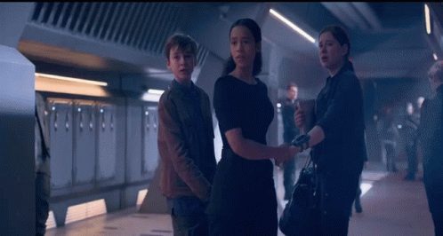 Man And Two Women Standing GIF