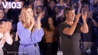 Man And Woman Applauding In Front Of Crowd GIF