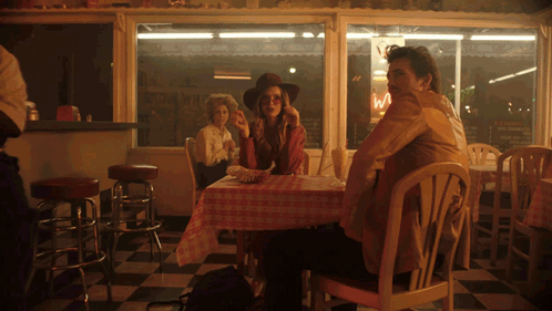 Man And Woman At Diner With Ice Cream Sign GIF