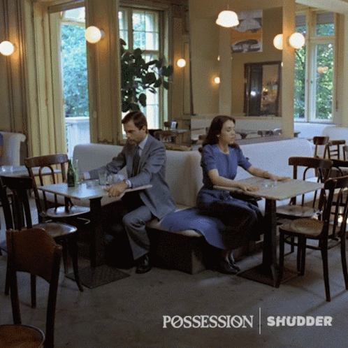 Man And Woman At Restaurant With Possession Shudder GIF