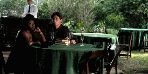 Man and Woman at Table With Green Tablecloth