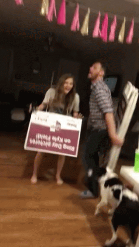 Man and Woman Carrying Nine Day Prints Sign