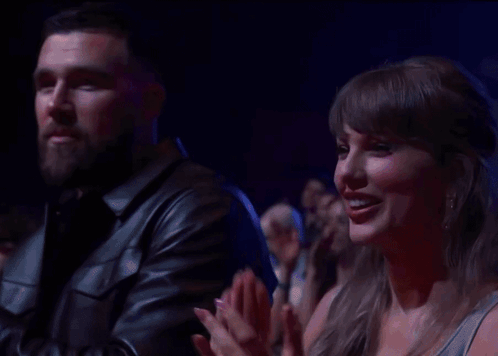 Man and Woman Clapping in Crowd