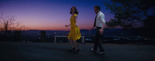 Man And Woman Dancing At Sunset City GIF
