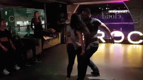 Man And Woman Dancing By Roc Sign GIF