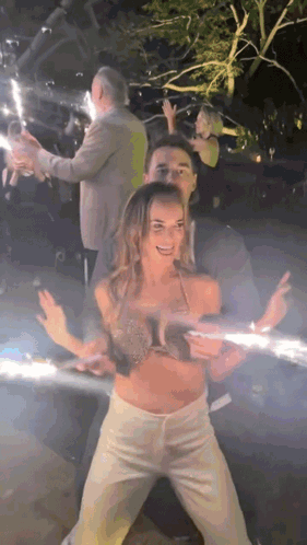 Man and Woman Dancing in Dark Room with Sparklers