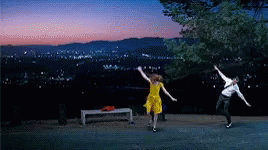 Man And Woman Dancing In Front Of City At Night GIF