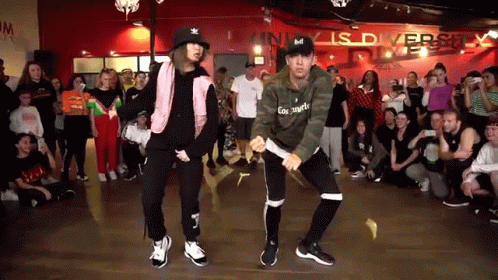 Man and Woman Dancing in Front of Crowd