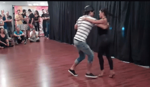 Man And Woman Dancing In Front Of Crowd GIF