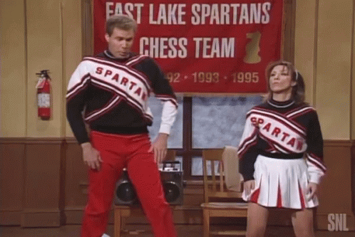 Man And Woman Dancing In Front Of Fast Lake Spartans Chess Team Sign GIF