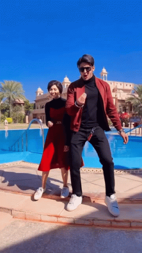 Man And Woman Dancing In Front Of Pool GIF