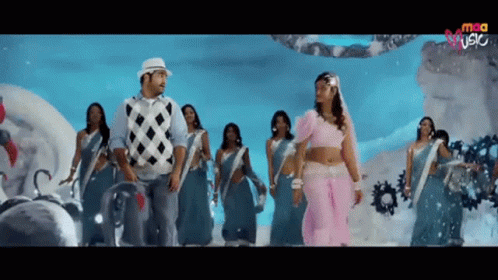 Man and Woman Dancing in Front of Screen Saying MCA
