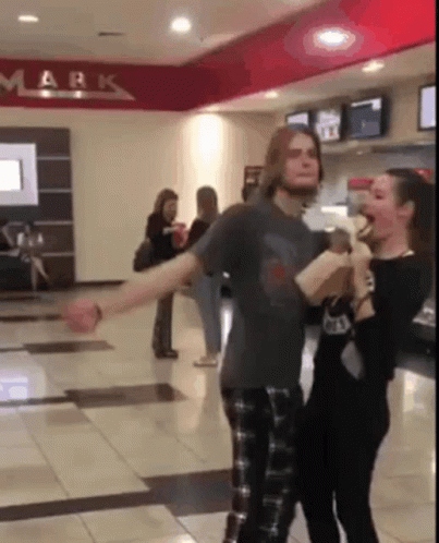 Man and Woman Dancing in Hallway With Mark on Ceiling
