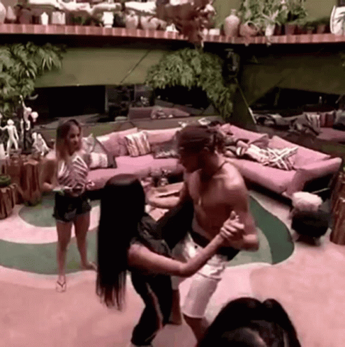 Man and Woman Dancing in Living Room With Pink Couch