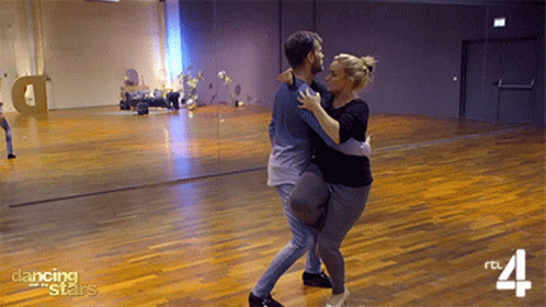 Man and Woman Dancing in Studio With Dancing Stars