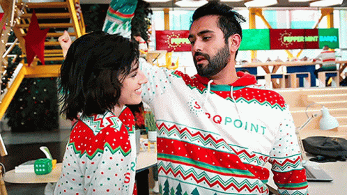 Man and Woman Dancing in Ugly Christmas Sweaters