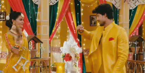 Man And Woman Dancing In Yellow And Red Room GIF
