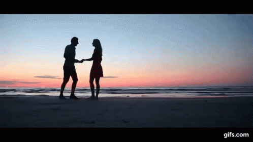 Man And Woman Dancing On Beach At Sunset GIF