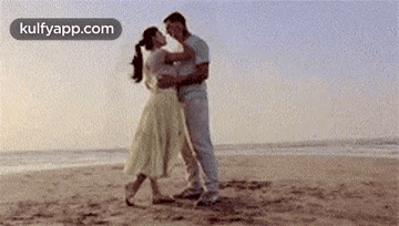 Man And Woman Dancing On Beach GIF