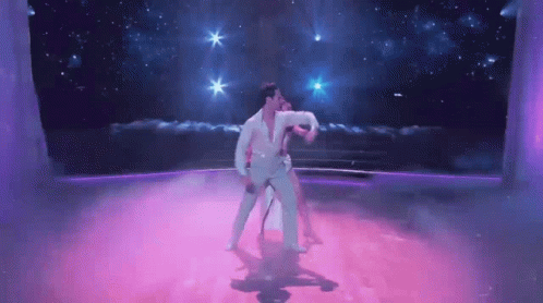 Man and Woman Dancing on Purple Dance Floor