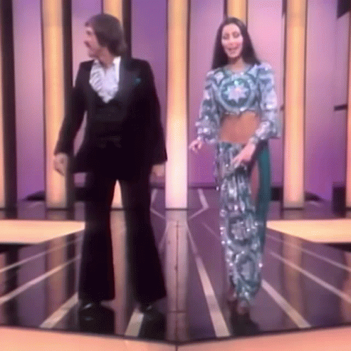 Man and Woman Dancing on Stage in Front of Mirror