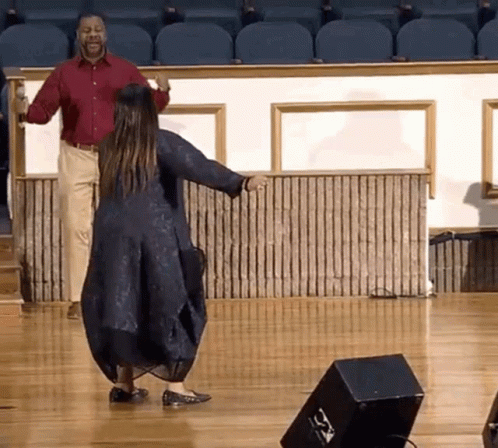 Man And Woman Dancing On Stage With Speaker GIF