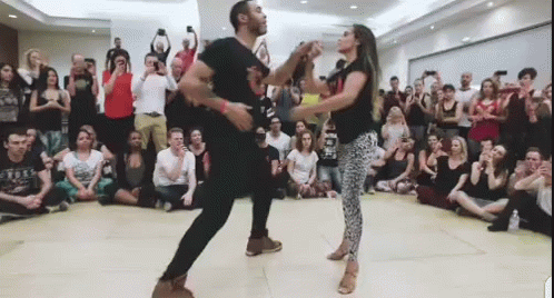 Man And Woman Dancing Salsa For Crowd GIF