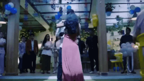 Man And Woman Dancing With Balloons GIF