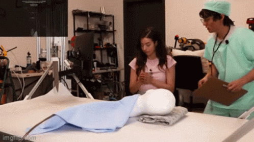 Man and Woman Doctors Looking at Mannequin
