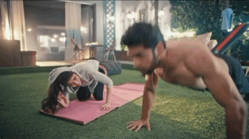 Man and Woman Doing Push Ups in Backyard