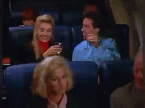 Man and Woman Drinking Beer on Airplane