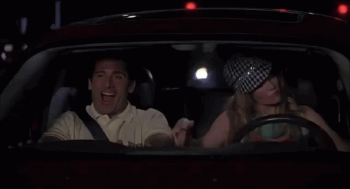 Man and Woman Driving at Night Woman Flexing Muscles