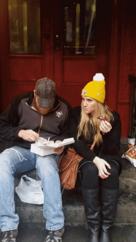 Man and Woman Eating on Steps