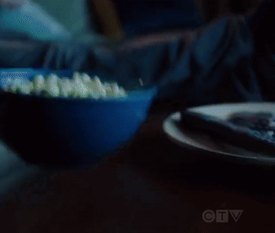 Man and Woman Eating Popcorn on Couch