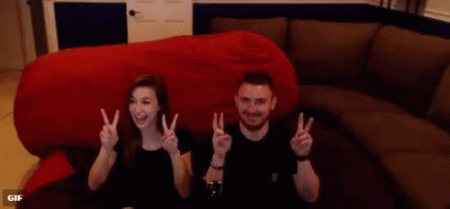 Man and Woman Giving Peace Signs