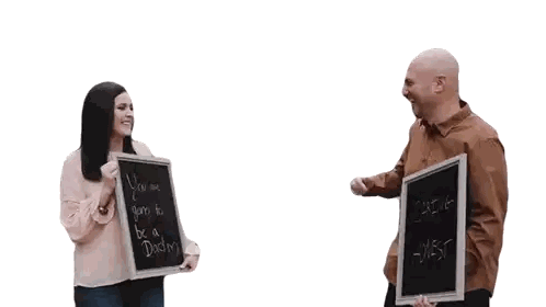 Man and Woman Holding Dad Announcement Chalkboard