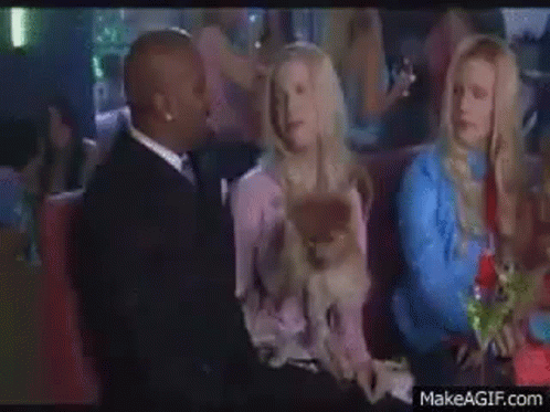 Man and Woman Holding Dog in Club