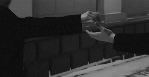 Man And Woman Holding Hands At Brick Wall GIF