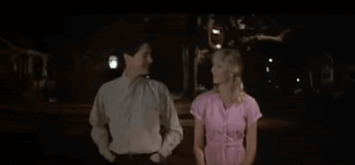 Man And Woman Holding Hands In Dark Room GIF