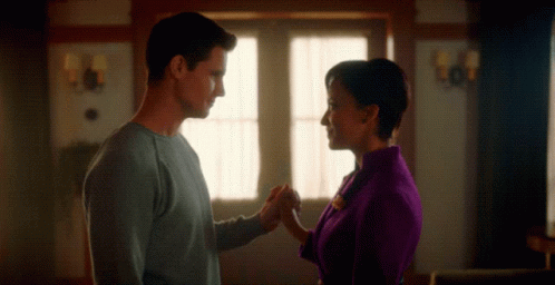 Man and Woman Holding Hands in Living Room