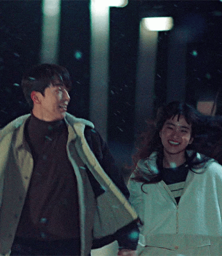 Man And Woman Holding Hands Smiling In Snow GIF