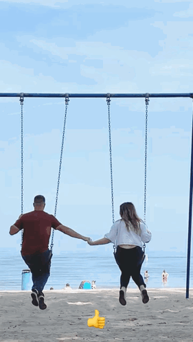 Man and Woman Holding Hands Swinging on Beach