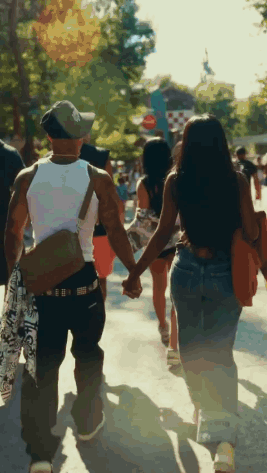 Man and Woman Holding Hands Walking Down Street