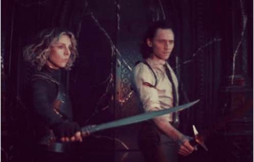 Man and Woman Holding Swords in Dark Room