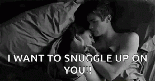 Man and Woman Hugging and Kissing in Bed