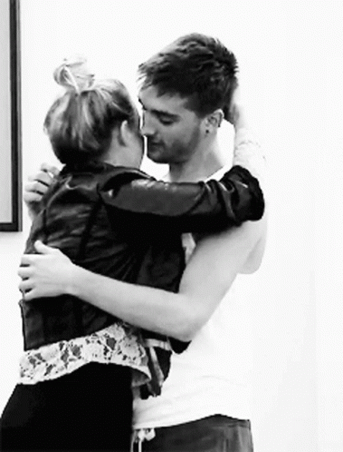 Man And Woman Hugging And Kissing In Black And White GIF