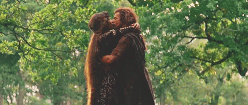 Man and Woman Hugging and Kissing in Woods