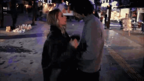 Man And Woman Hugging And Kissing On Street At Night GIF